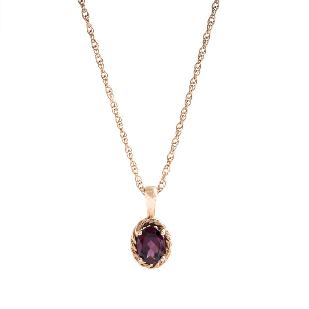 Yellow gold pendant necklace centered with garnet.