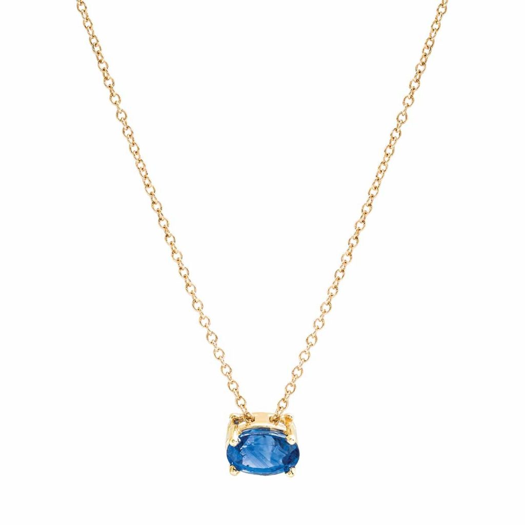 Yellow gold pendant necklace set with blue sapphire.