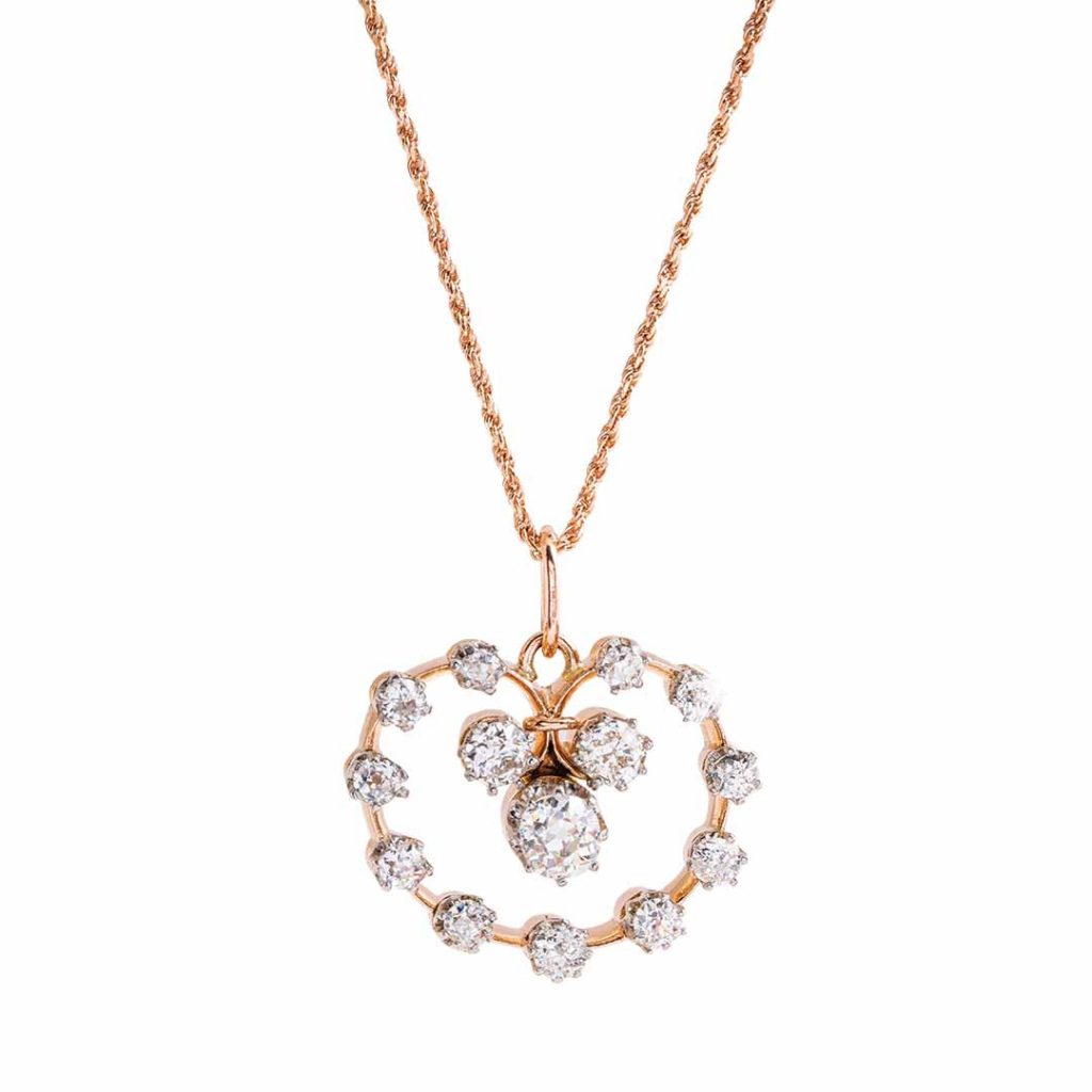 Rose gold open circle drop pendant necklace set with diamonds.