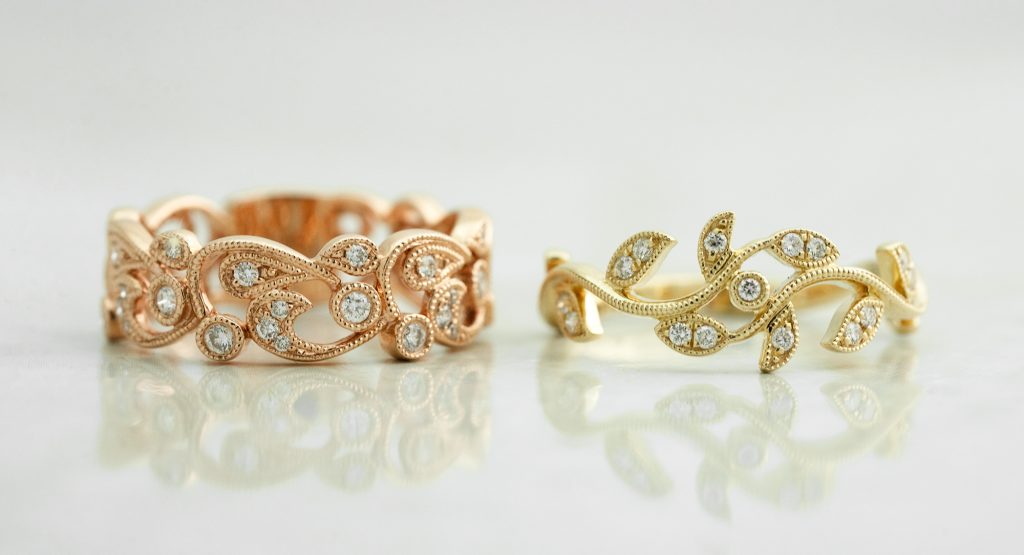 Yellow gold and rose gold vine wedding bands both set with diamonds.