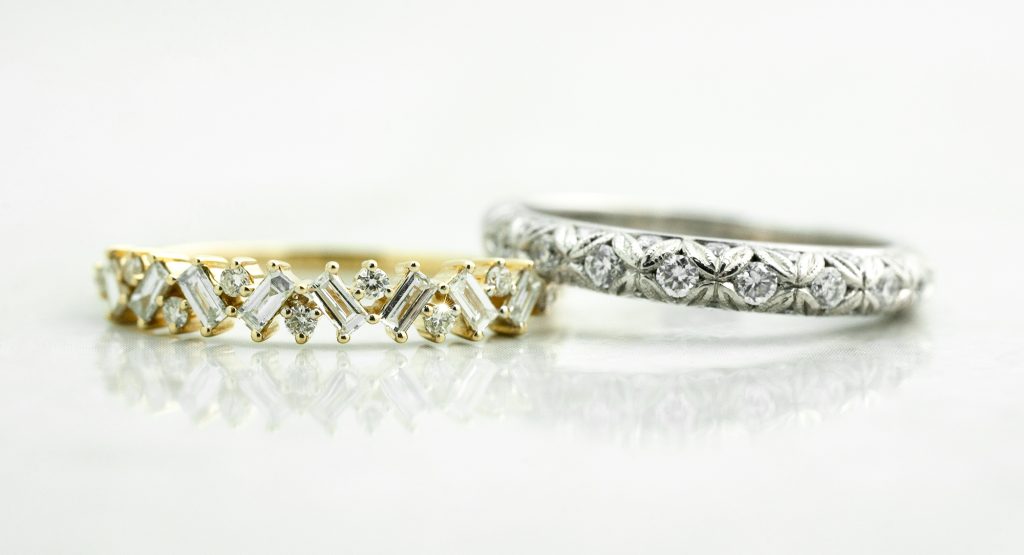 Yellow gold and white gold wedding bands both set with diamonds.