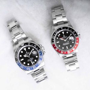 Two pre-owned men’s Rolex watches in stainless steel with black dials.