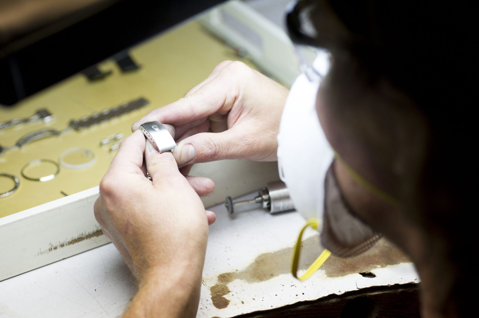 Watchmaker working on a watch repair at their bench.