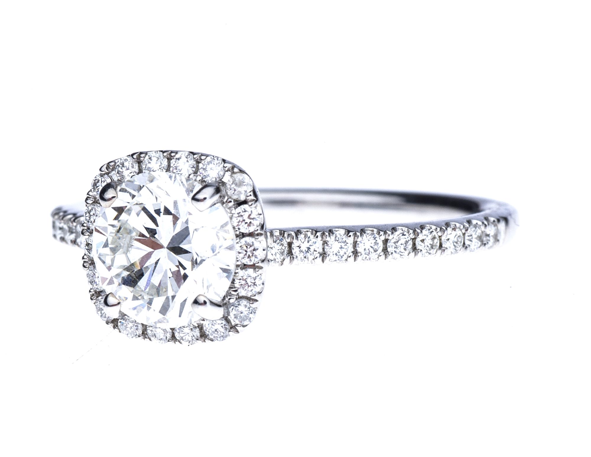 White gold diamond engagement ring with a diamond halo and diamonds in the band.