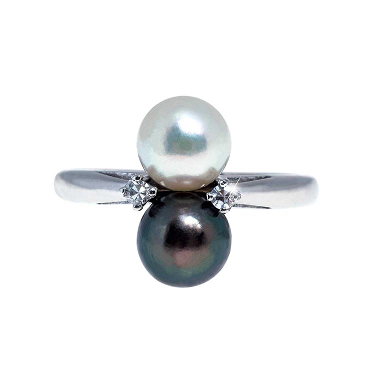 White gold ring set with diamonds, white, and Tahitian pearls.