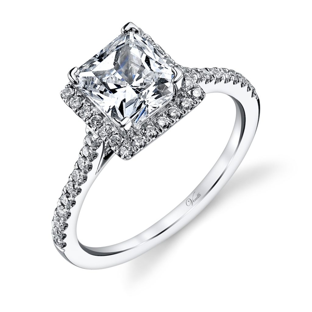 White gold cathedral diamond engagement ring with a square diamond halo and diamonds in the band.