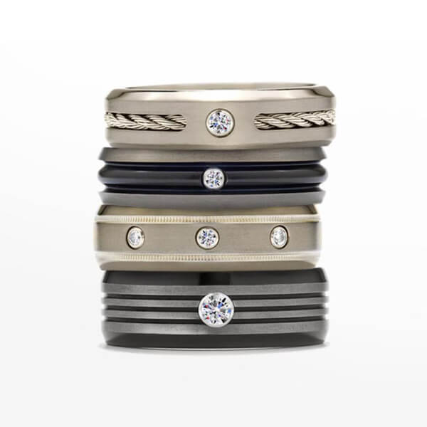 Four vintage Neil Lane diamond wedding bands stacked.