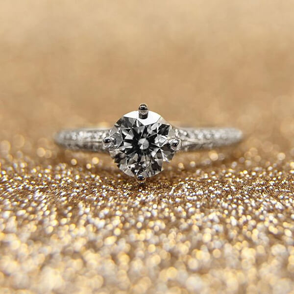 White gold diamond engagement ring with diamonds in the band.