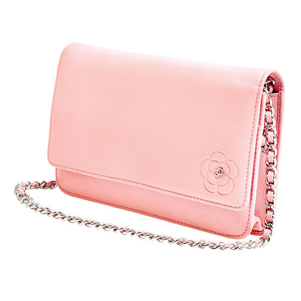 Vintage pink leather Chanel handbag with leather and chain strap and flower
embossment.