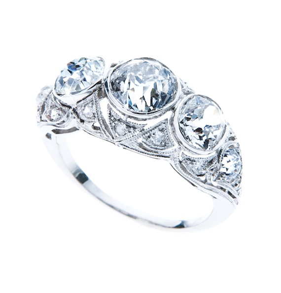 Edwardian platinum three-stone engagement ring set with diamonds.