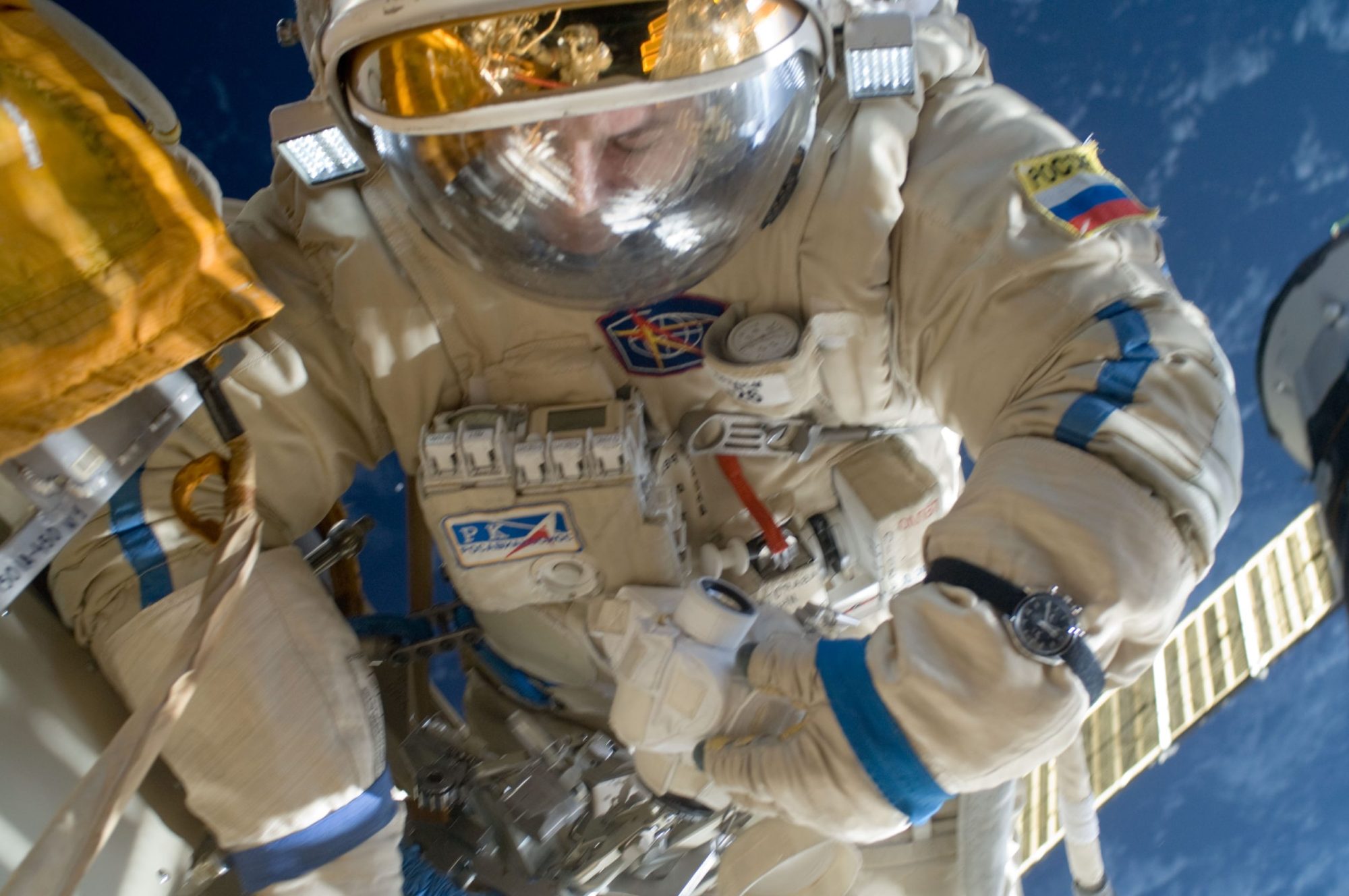 Astronaut in space wearing an Omega Speedmaster watch.