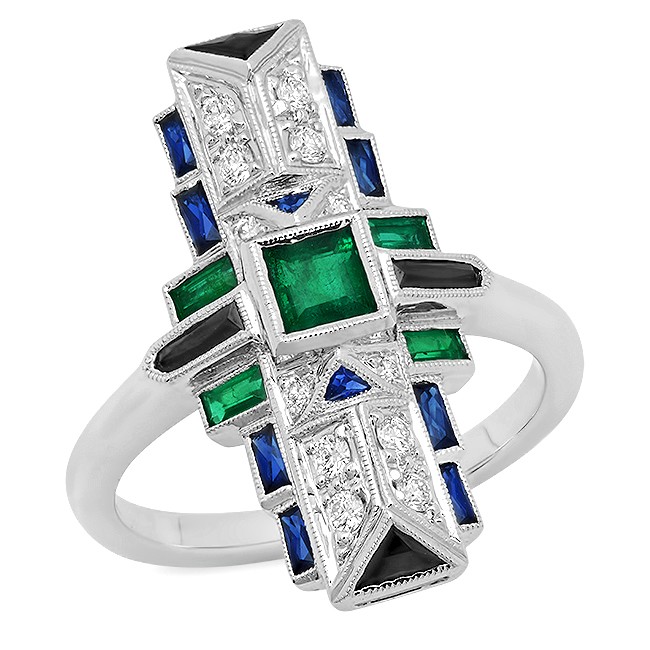 White gold cocktail ring set with diamonds, emeralds, and blue sapphires.