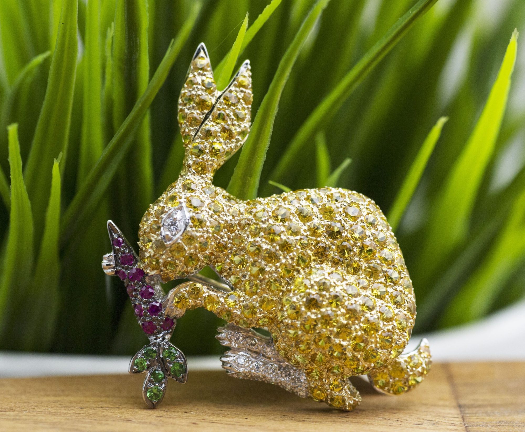 Yellow gold bunny brooch set with yellow sapphires, diamonds, rubies, and emeralds.