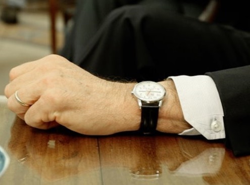 Close-up of George W. Bush wearing a luxury watch.