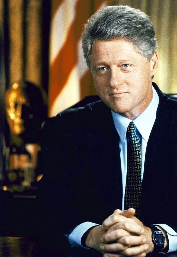 Bill Clinton wearing a luxury watch.