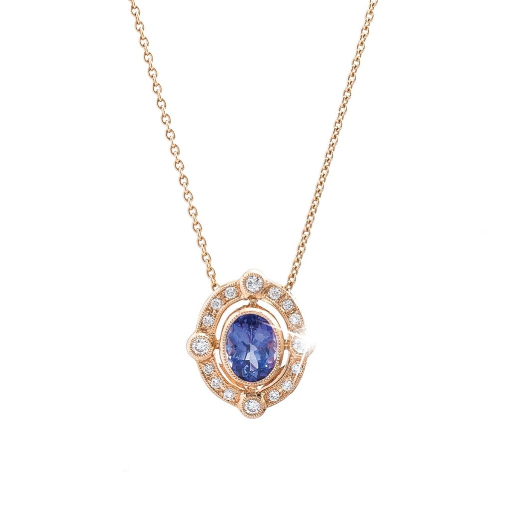 Yellow gold necklace centered with tanzanite surrounded by diamonds.