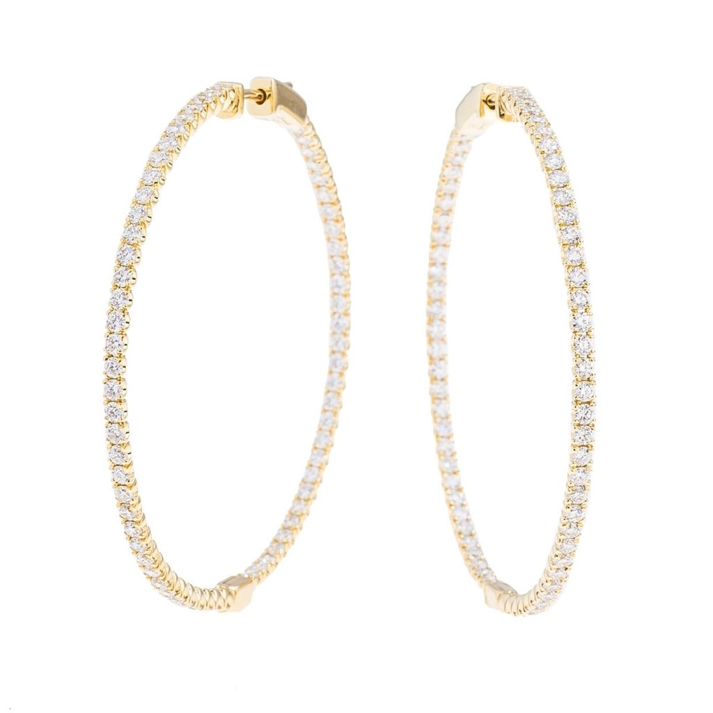 Yellow gold hoop earrings set with diamonds.