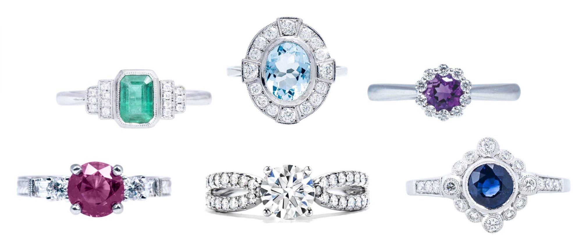 Six white gold engagement rings all centered with various precious gemstones
surrounded by diamonds.