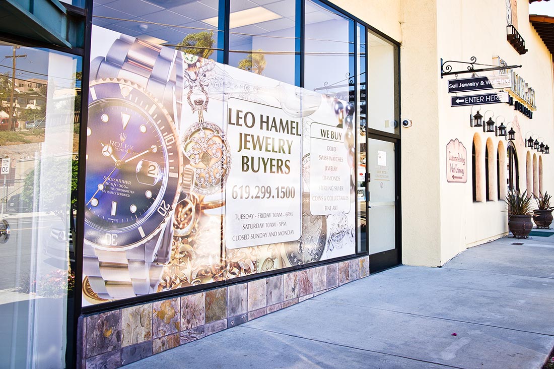 Storefront of Leo Hamel Jewelry Buyers featuring large promotional signage displaying a Rolex watch and text about buying jewelry.