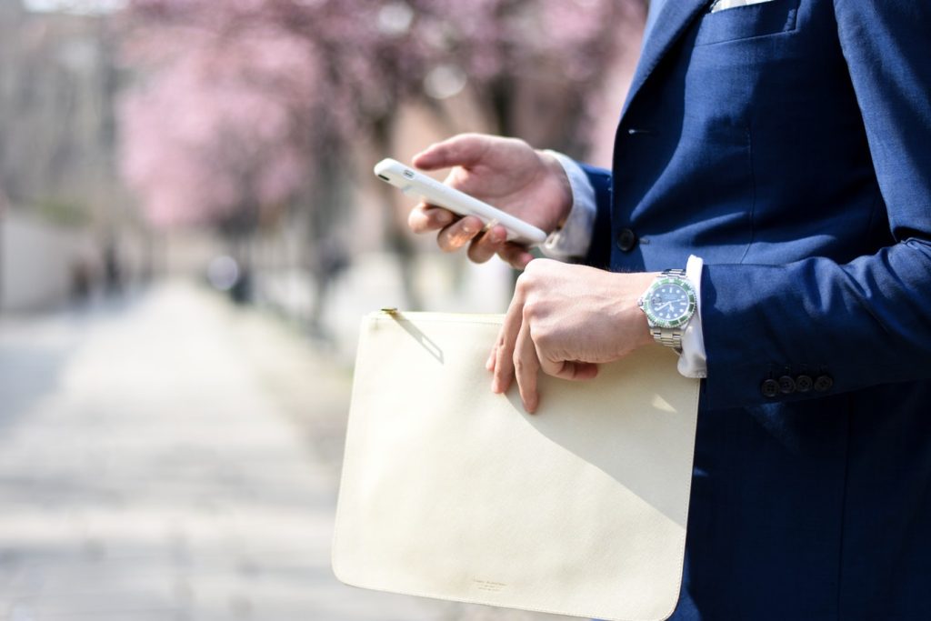 Man in blue suit wearing a Rolex.