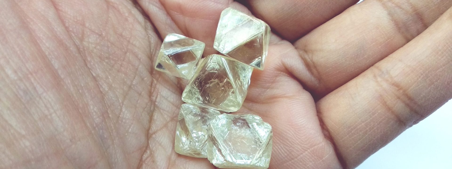 Handful of rough uncut diamonds.