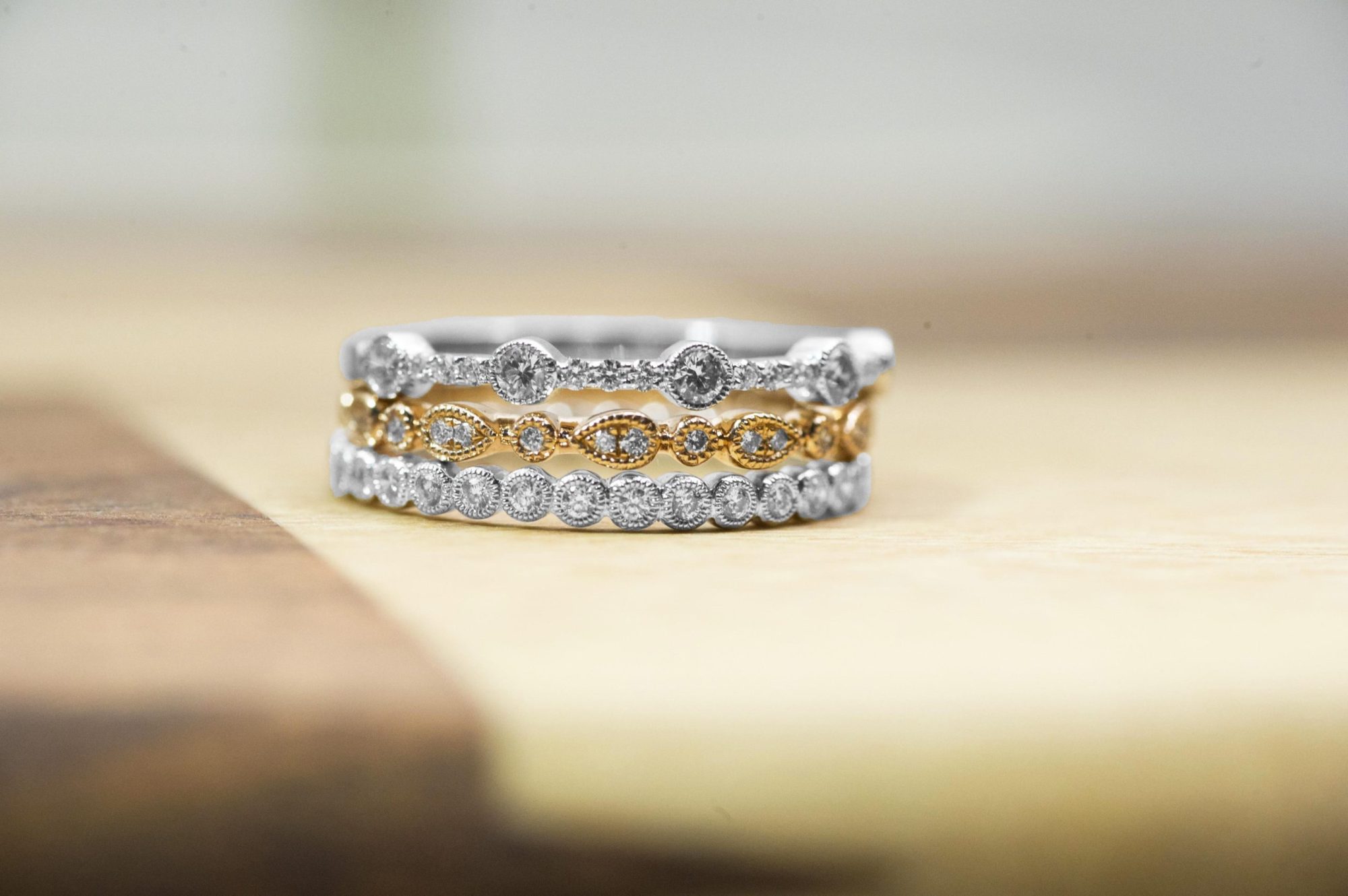 White and rose gold stacking diamond eternity rings.