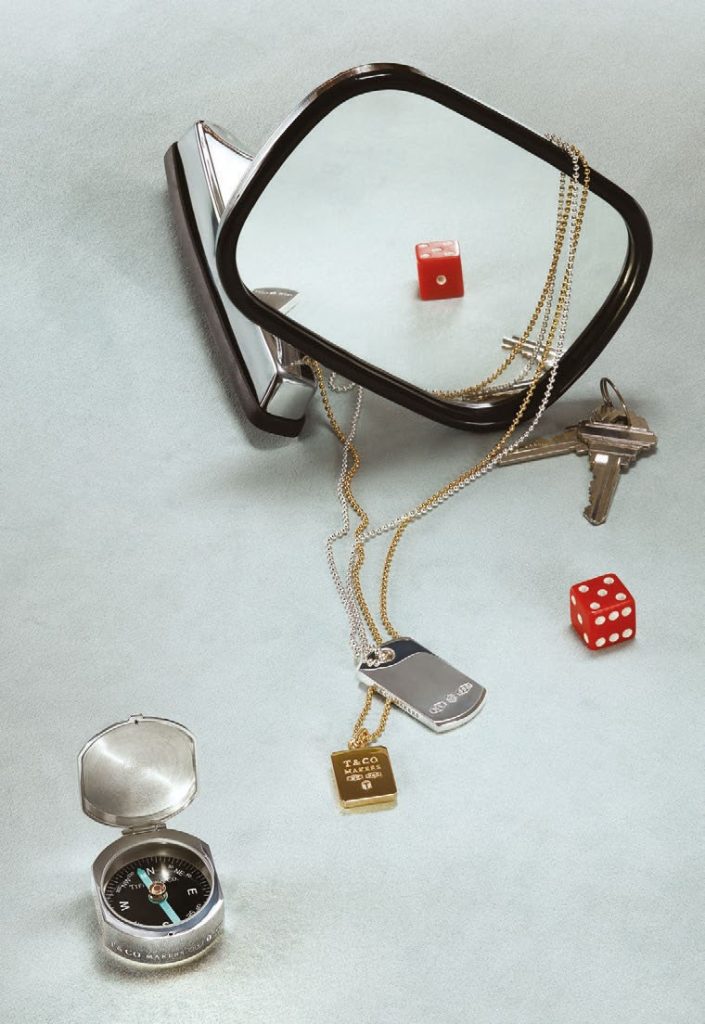 Various vintage Tiffany & Co. men’s accessories on white table.