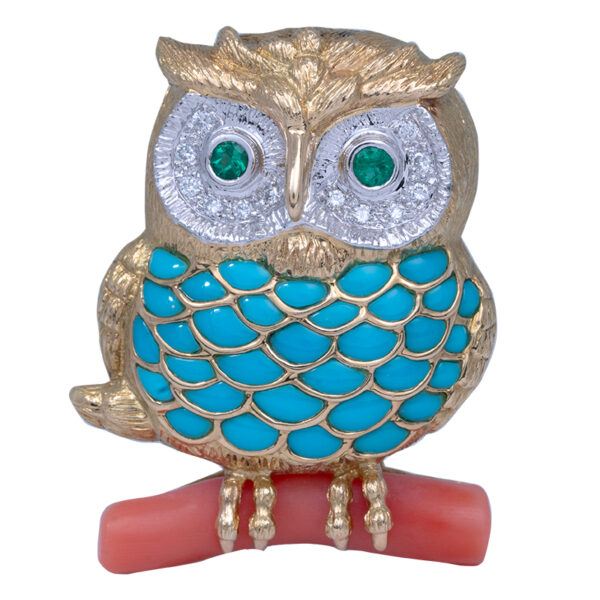 gold owl brooch with turquoise feathers, a coral branch, white diamond and emerald eyes