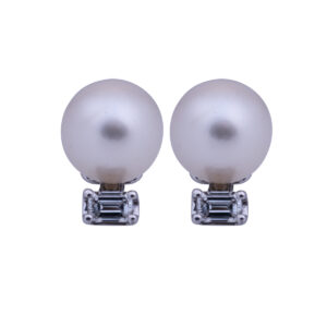 drop earrings set with white pearls and emerald cut diamonds