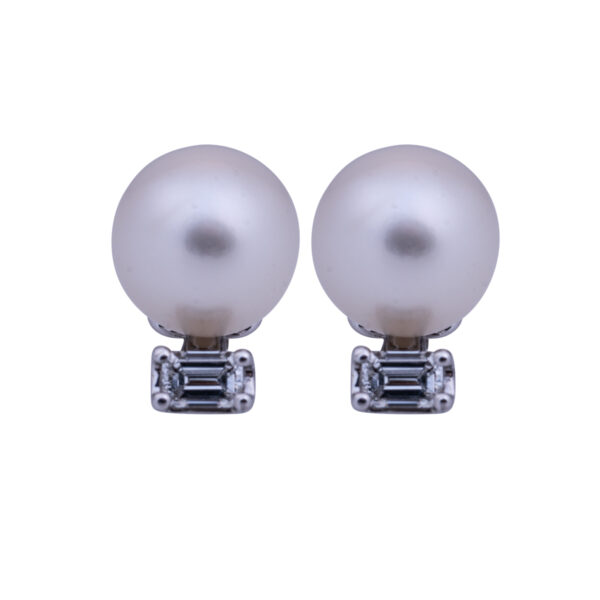 drop earrings set with white pearls and emerald cut diamonds