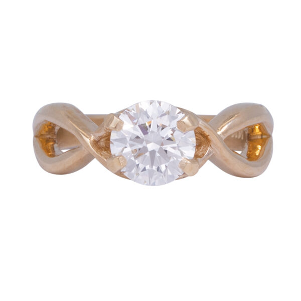 yellow gold crossover ring set with a round brilliant diamond