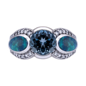 white gold 3 stone ring centered with a rich aquamarine flanked by blue green opals