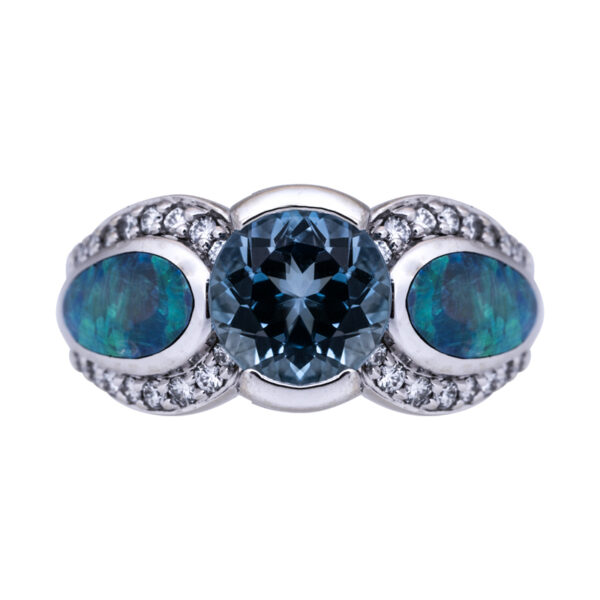 white gold 3 stone ring centered with a rich aquamarine flanked by blue green opals