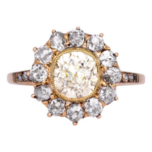 antique yellow gold halo engagement ring centered with a light fancy yellow diamond surrounded by white diamonds